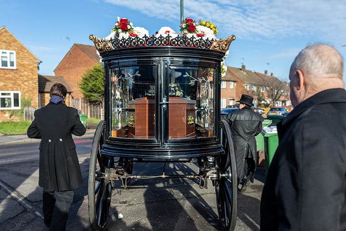 Hearse being escorted with horses